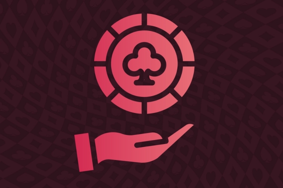 A hand holding a clover icon representing casino games